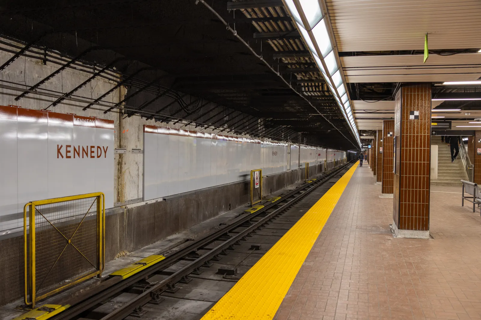 Line 2 subway platform at Kennedy station with the new panels on the wall, replacing the old vertical red slats.